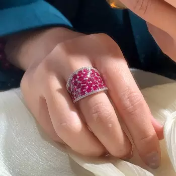 25.5ctw Oval Shaped Ruby Saddle Ring with Diamond Prongs