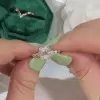 Unique Rose Gold Tone Oval Cut White Sapphire Ring with Curved Eternity Band