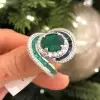 Oval Cut Emerald and Sapphire Crossover Engagement Ring