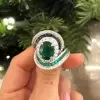 Oval Cut Emerald and Sapphire Crossover Engagement Ring
