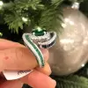 Oval Cut Emerald and Sapphire Crossover Engagement Ring
