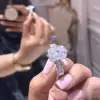 Cushion Cut 3 Carat Encrusted Engagement Ring Following By Multi Shaped Eternity Band