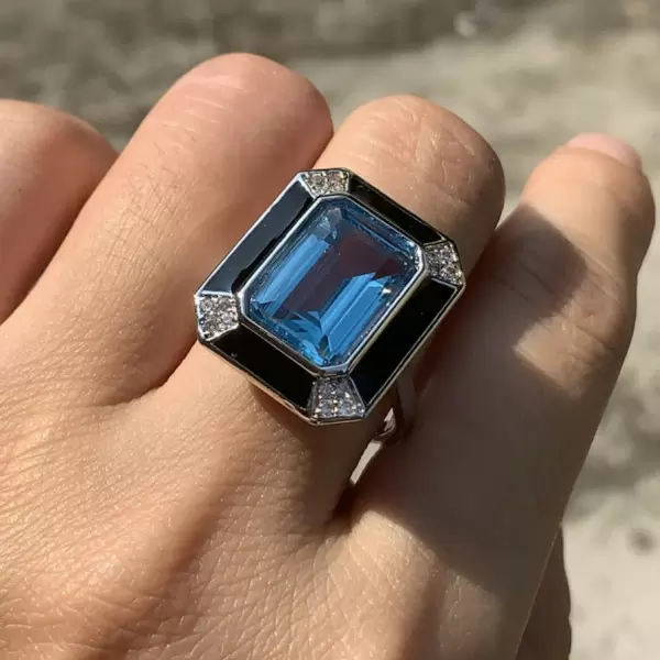 Emerald cut blue hotsell topaz engagement ring