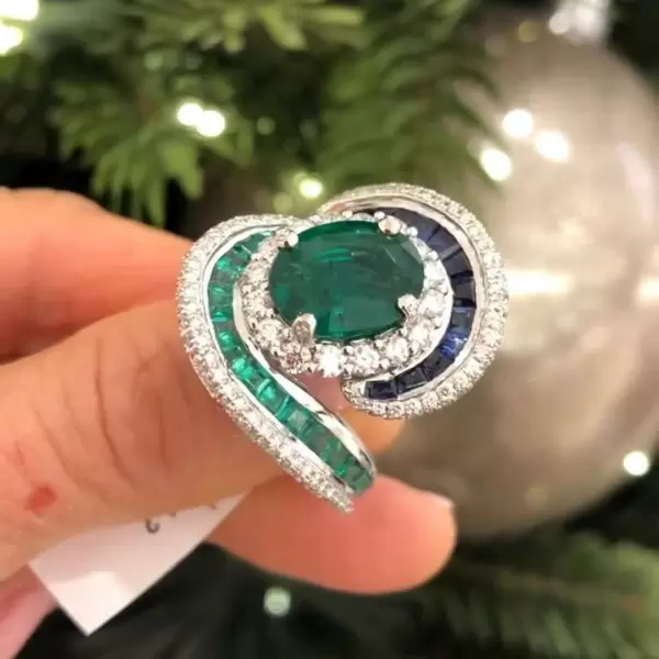 Oval Cut Emerald and Sapphire Crossover Engagement Ring