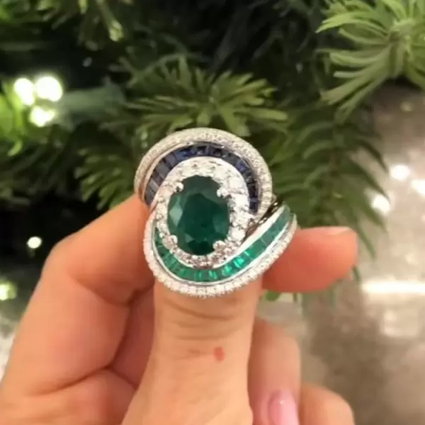 Oval Cut Emerald and Sapphire Crossover Engagement Ring